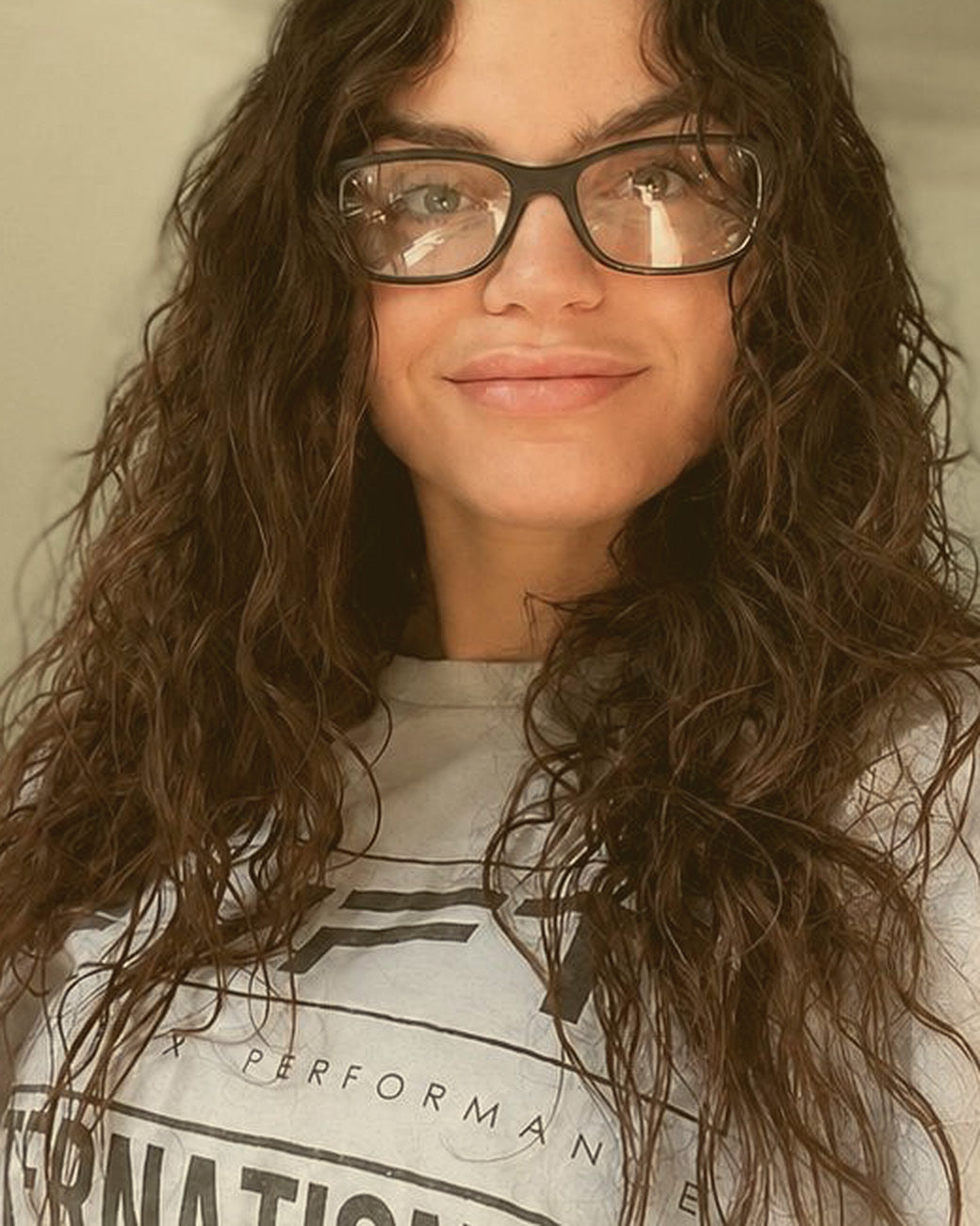 Founder before: shorter, frizzy, heat-damaged curly hair